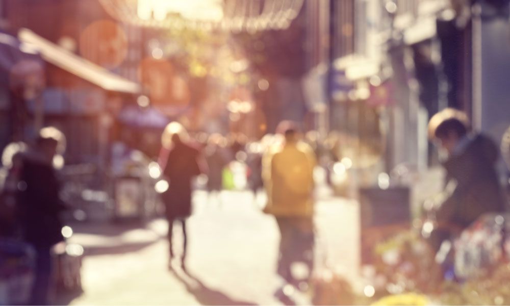 Residents and visitors walking down a city street